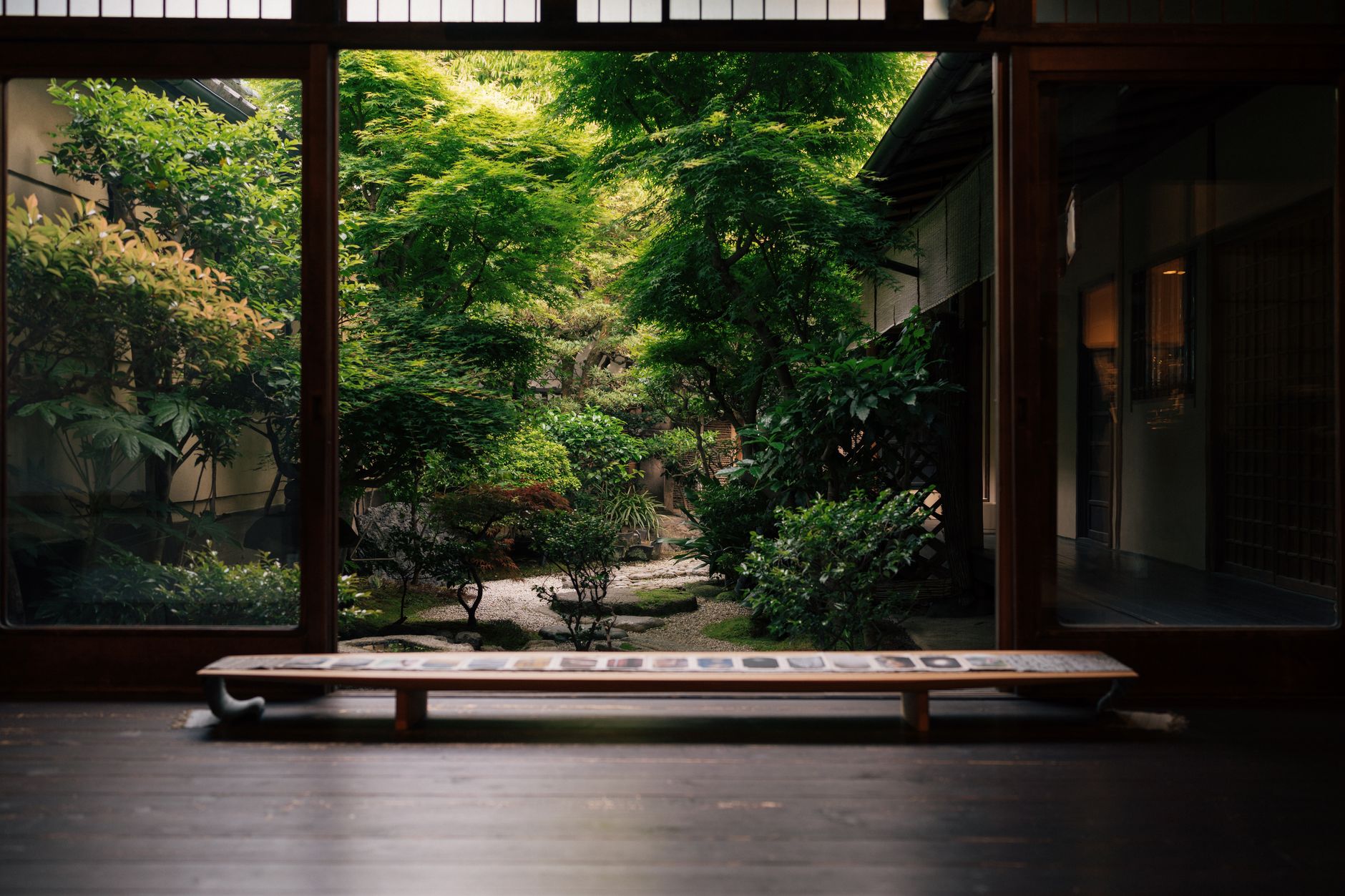 A Japanese garden seen from inside a traditional wooden house