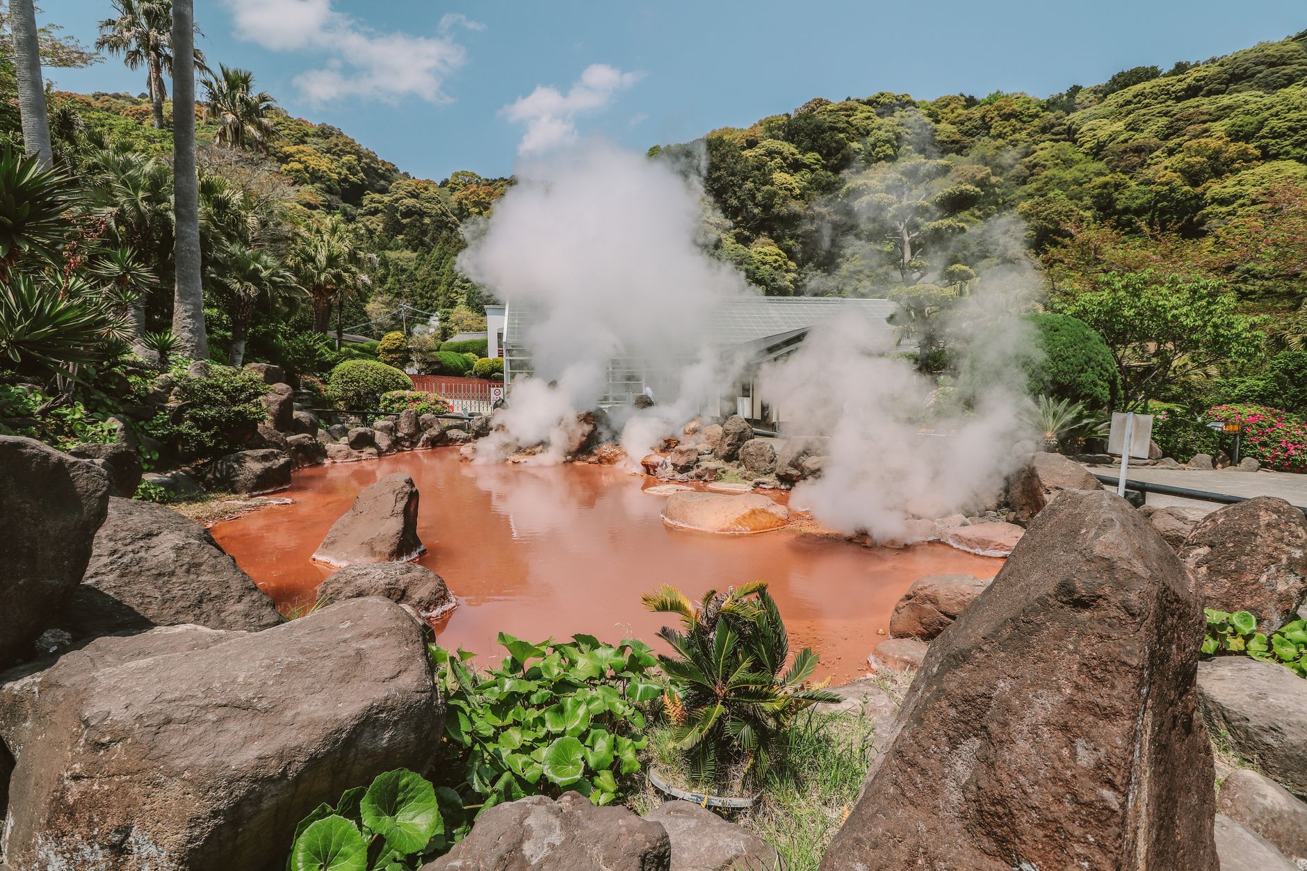 Steam rising from a natural hot spring — the hot-spring bathing style this section describes