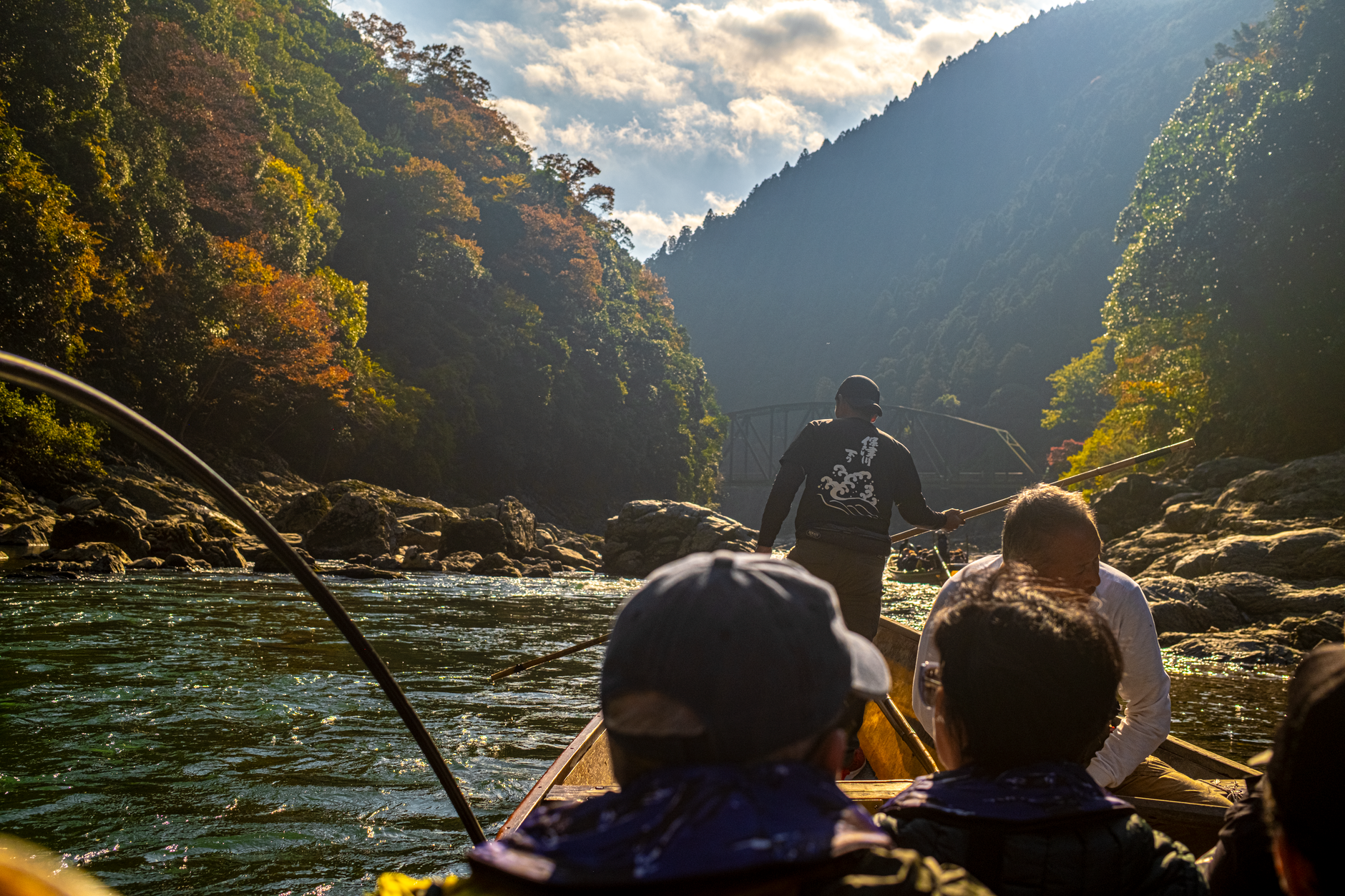 A traditional wooden boat on a quiet river gorge in Japan