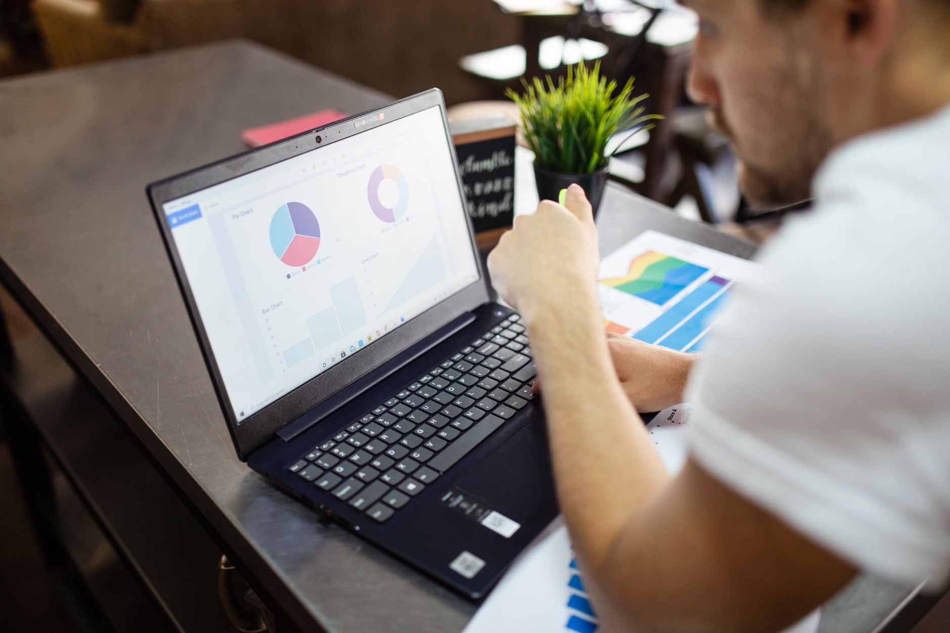 A small business owner reviewing a sales data chart on a laptop