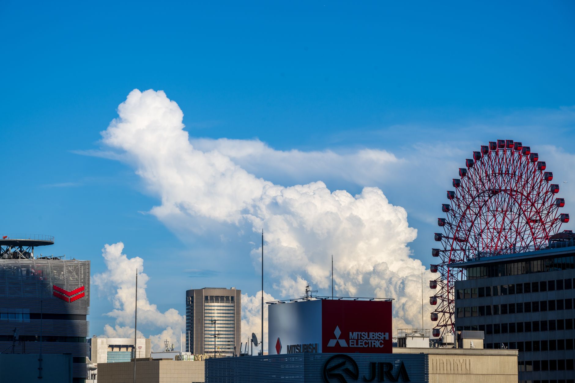 The Umeda skyline in Osaka with the red HEP Five ferris wheel above the Hankyu buildings