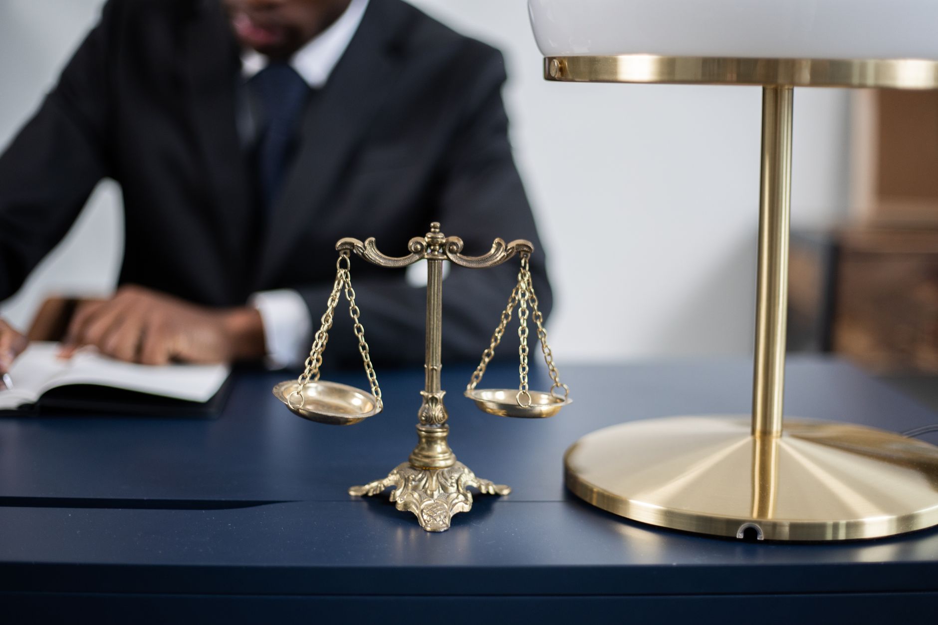 Scales of justice on a desk in a professional office setting