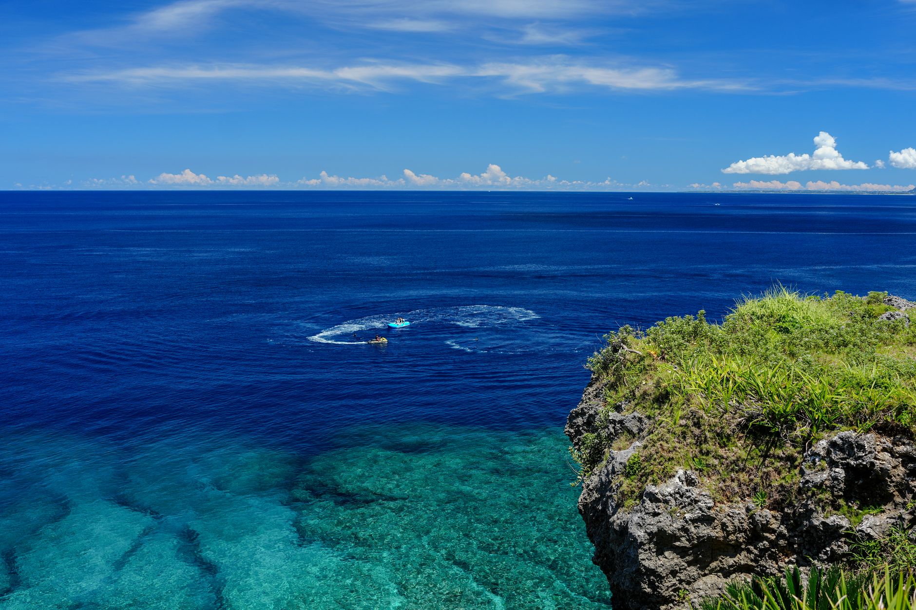 Turquoise sea and a rocky coastline in Okinawa on a sunny day