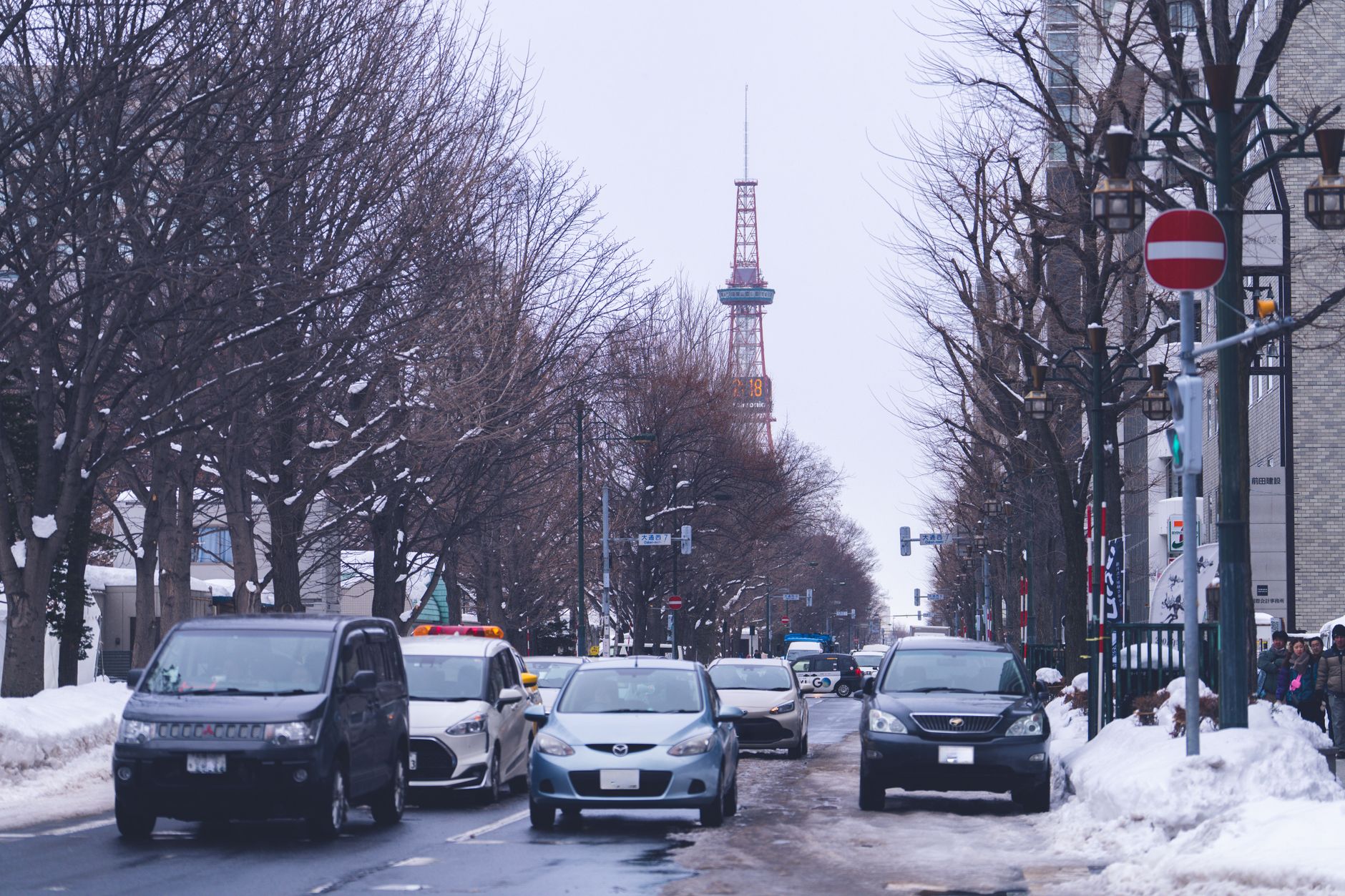 Snow-lined street in Sapporo, Hokkaido, with the Sapporo TV Tower in the distance