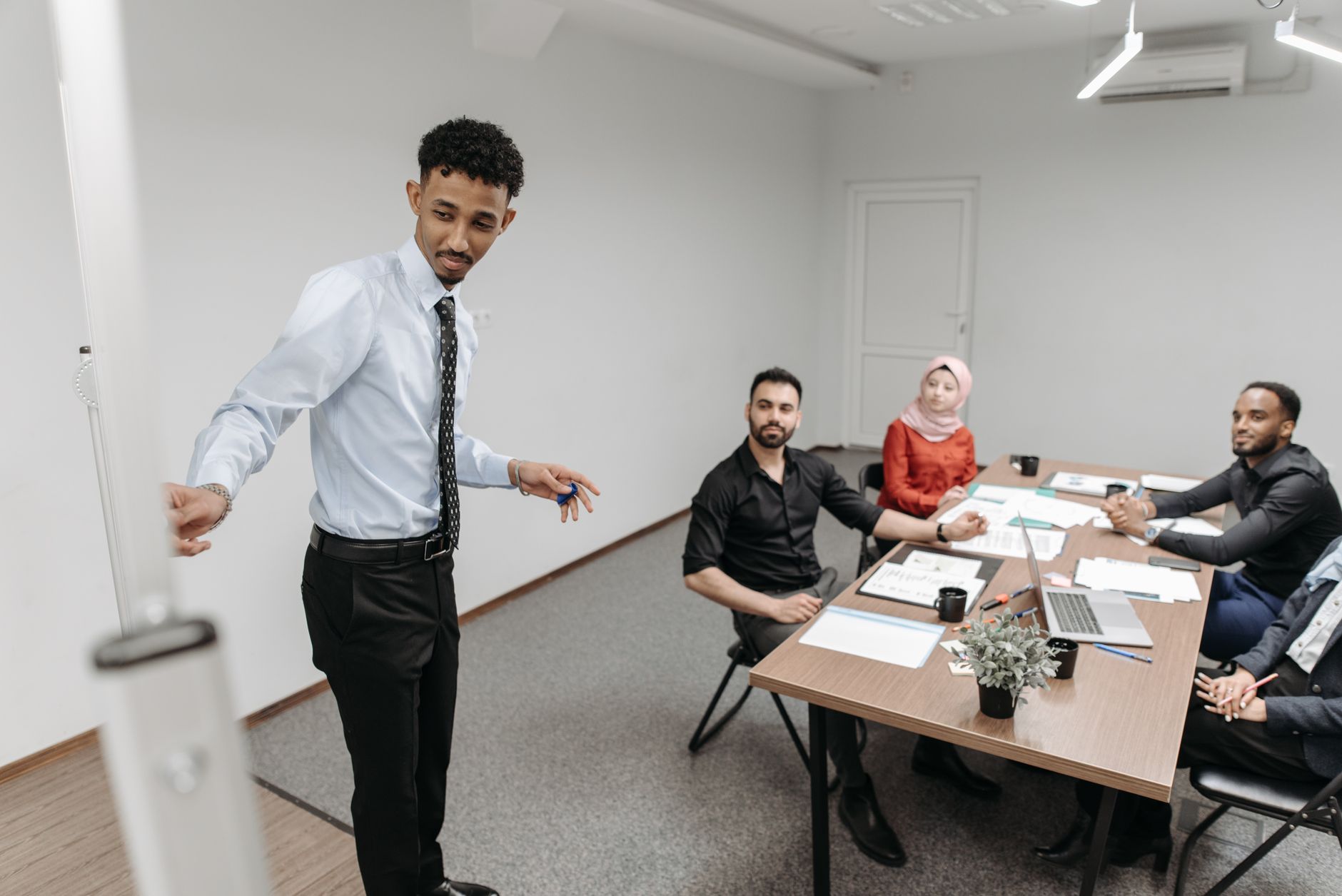 Colleagues in a corporate meeting reviewing materials