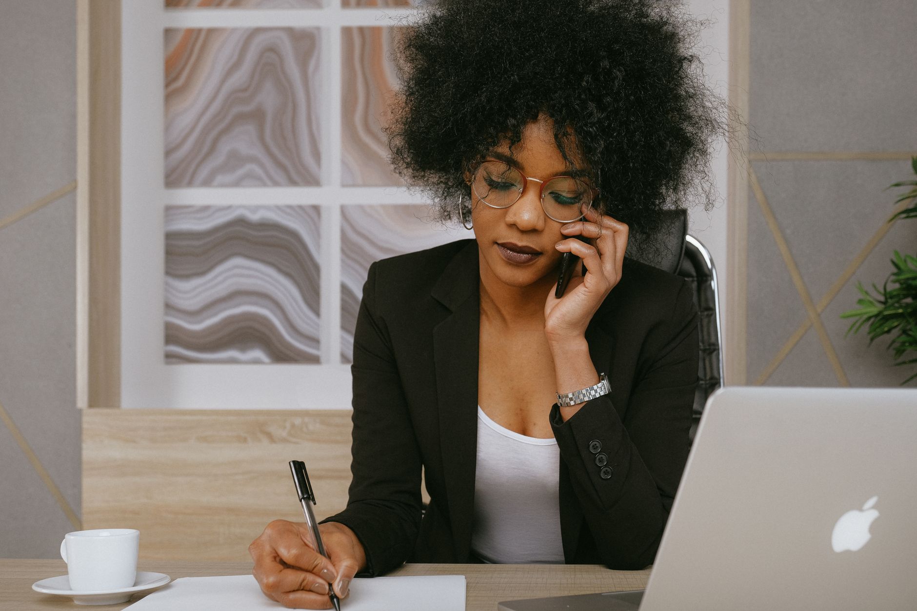 A salesperson working through a backlog of leads at a busy desk