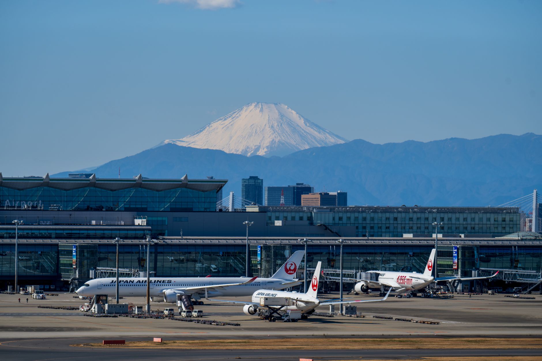 Haneda Airport terminal with ANA aircraft and Mount Fuji in the background
