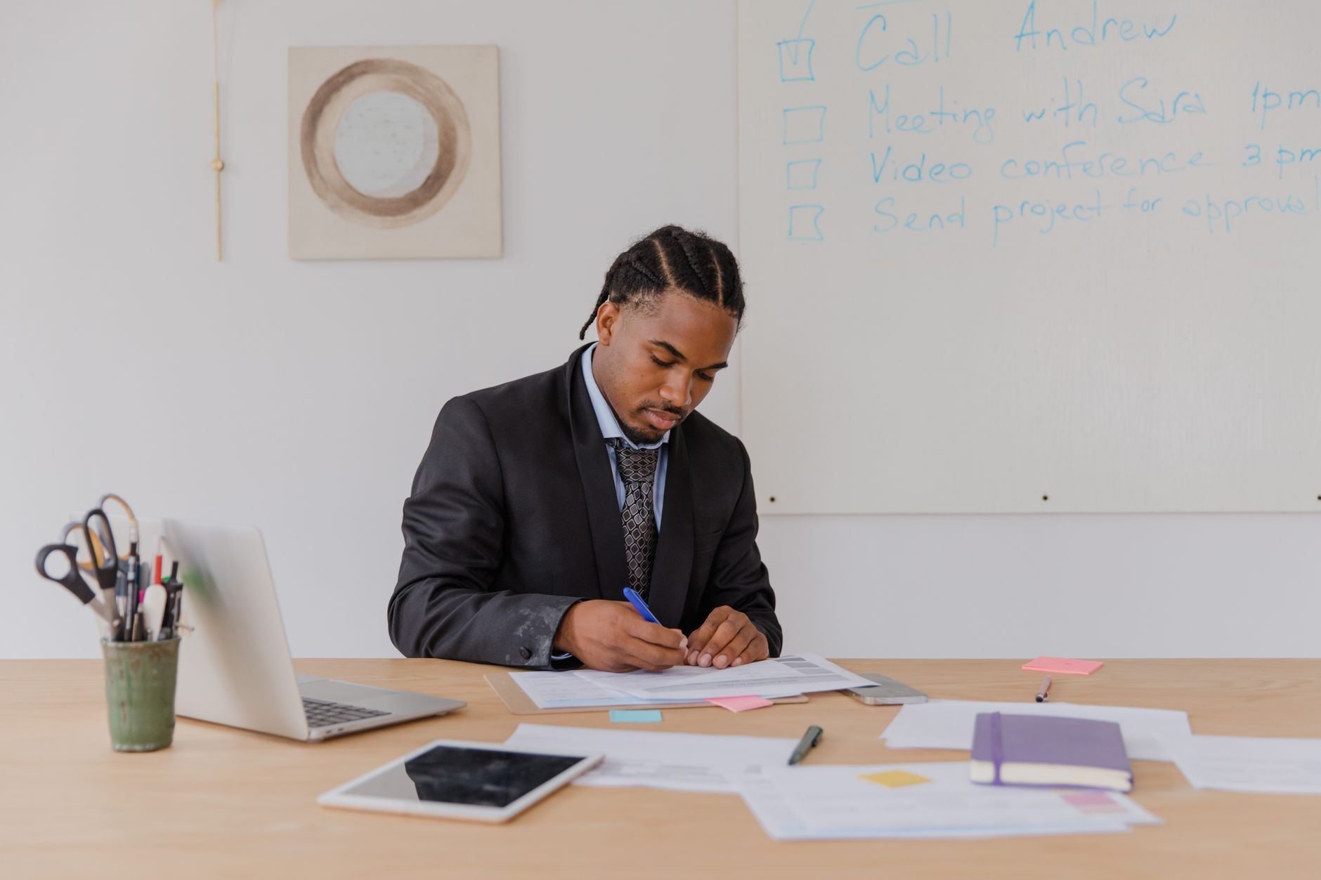 A small business owner organizing FAQ and knowledge-base documents on a laptop