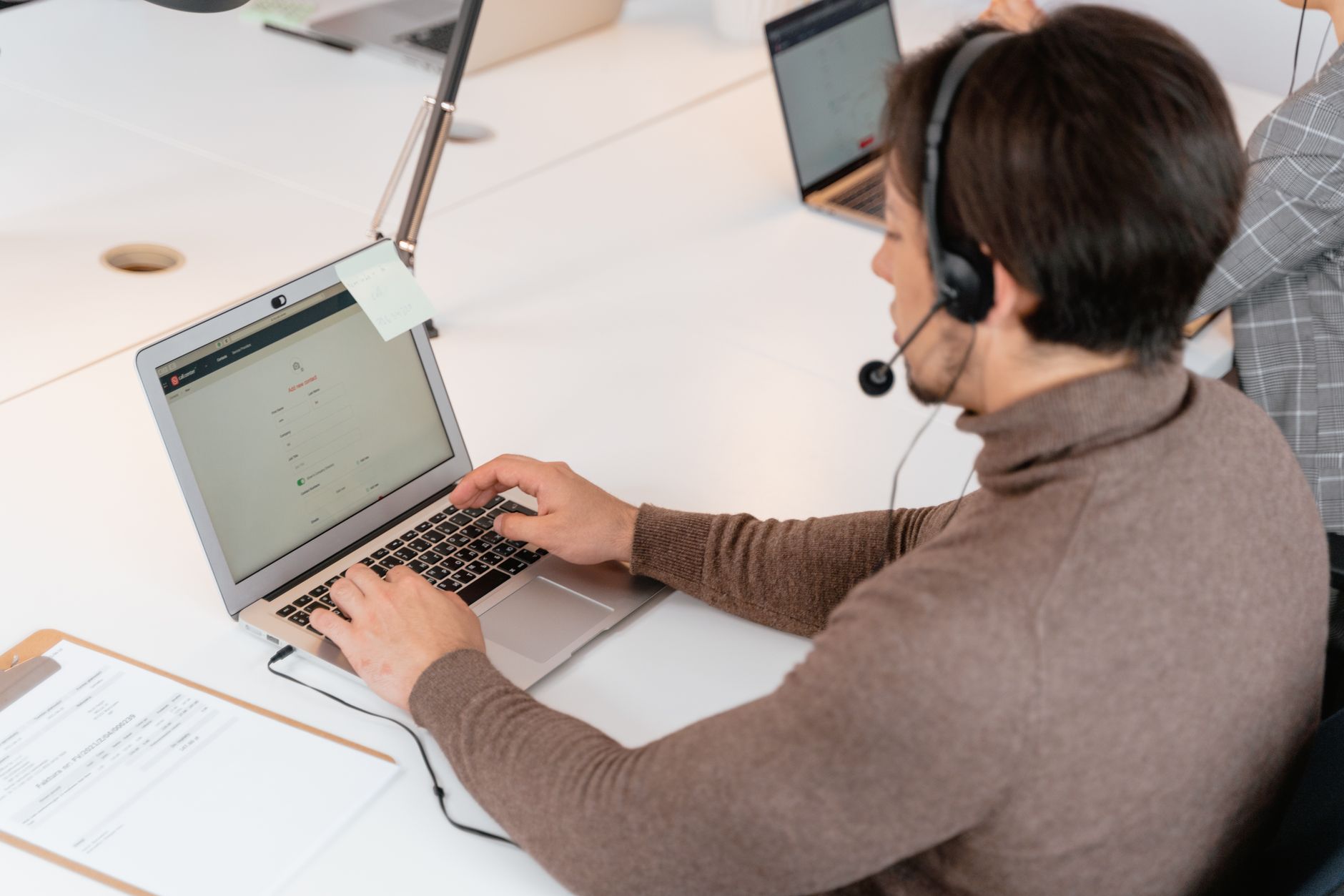 Person filling out a contact form on a laptop